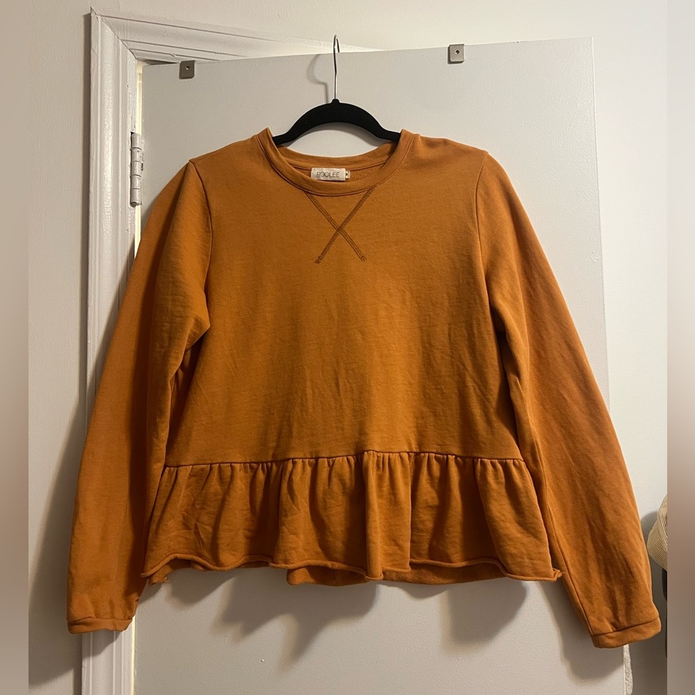 Burnt orange peplum top. Raw bottom hem and heavier weight than a long sleeve.